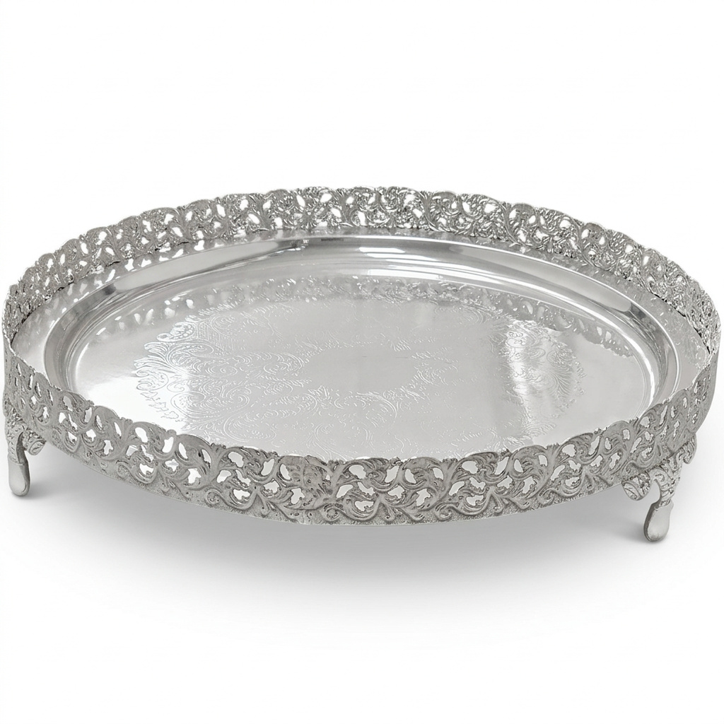 A round silver serving tray with an ornate filigree raised rim and small feet, shown on a clean white background.